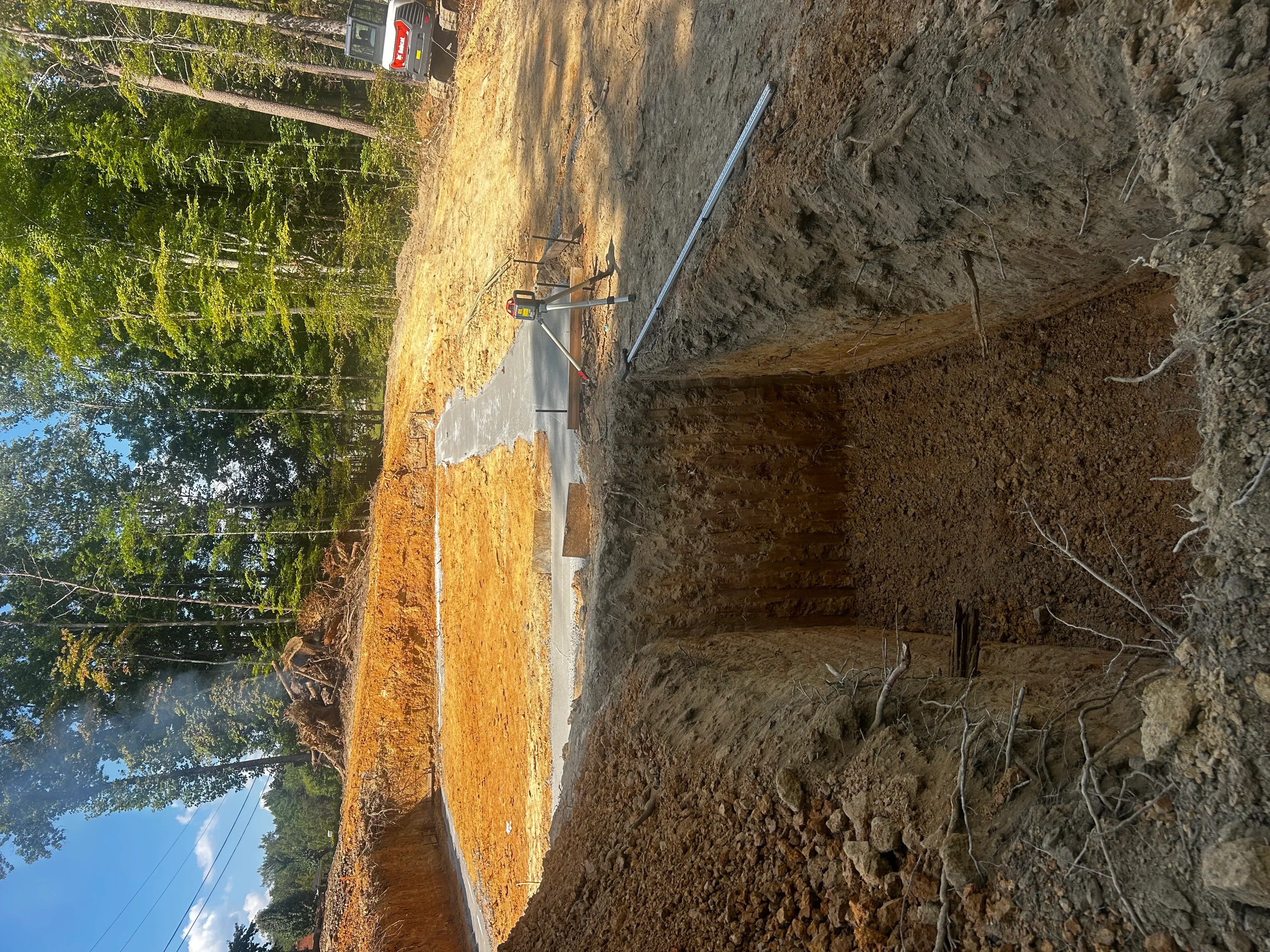 Septic tank installation with PVC piping and excavated drain field area