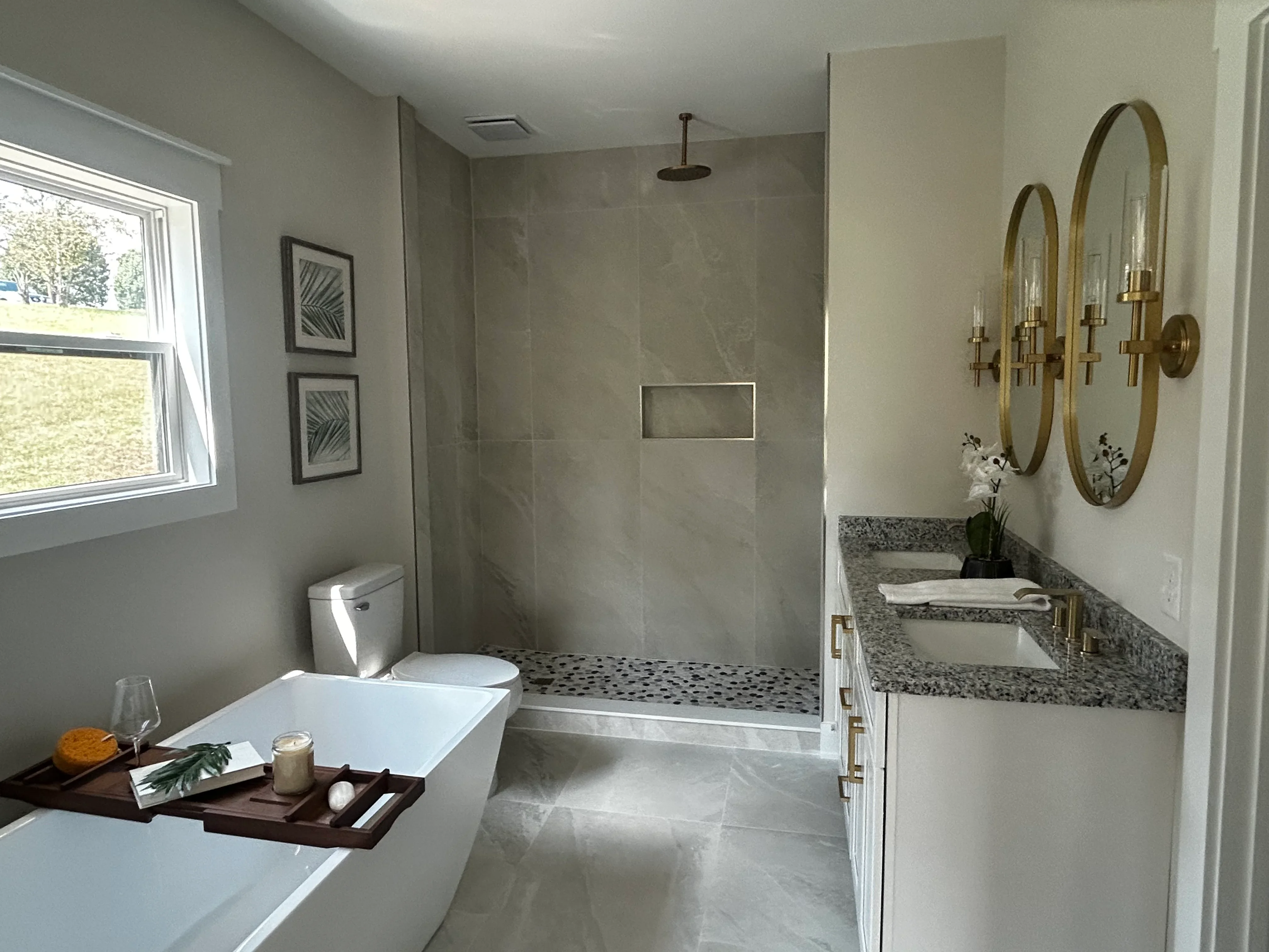 Master bathroom with walk-in shower, dual vanity, granite counters, and freestanding tub